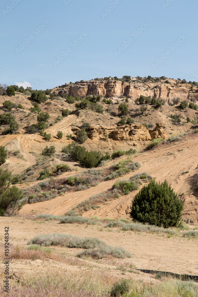 Sandstone rock formations and sand trails at The Dunes in Farmington, NM Sandstone rock formations and sand trails at The Dunes in Farmington, NM