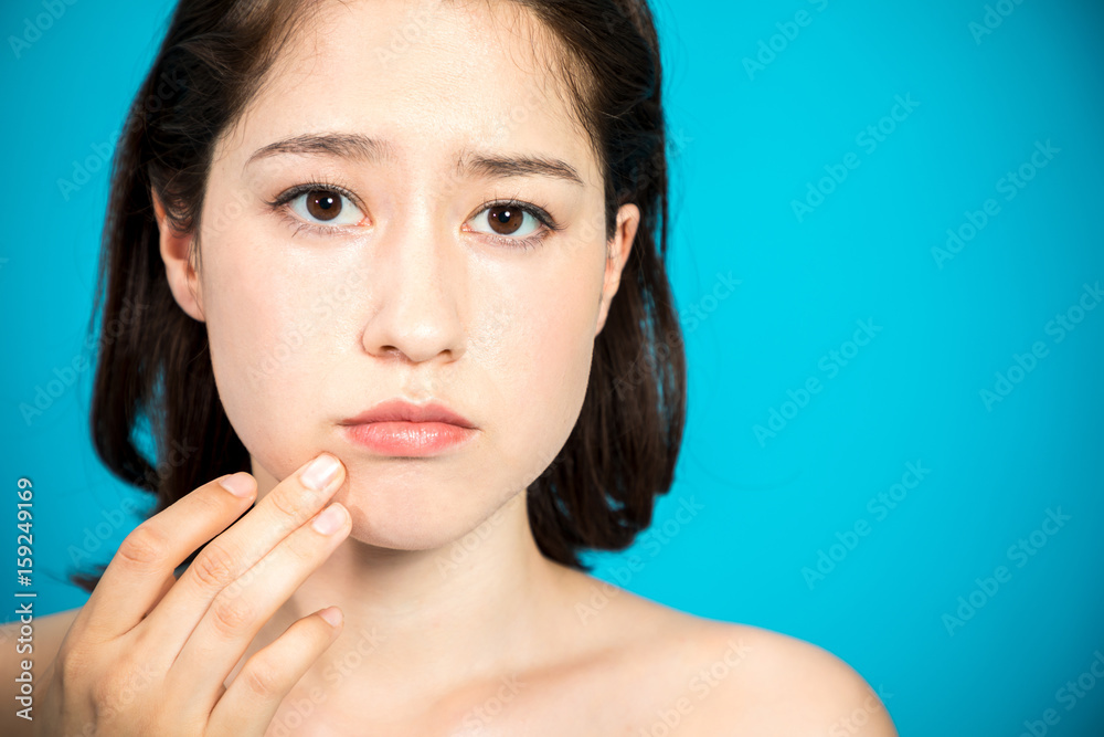young woman who checks her skin. acne treatment. young woman who checks her skin. acne treatment.
