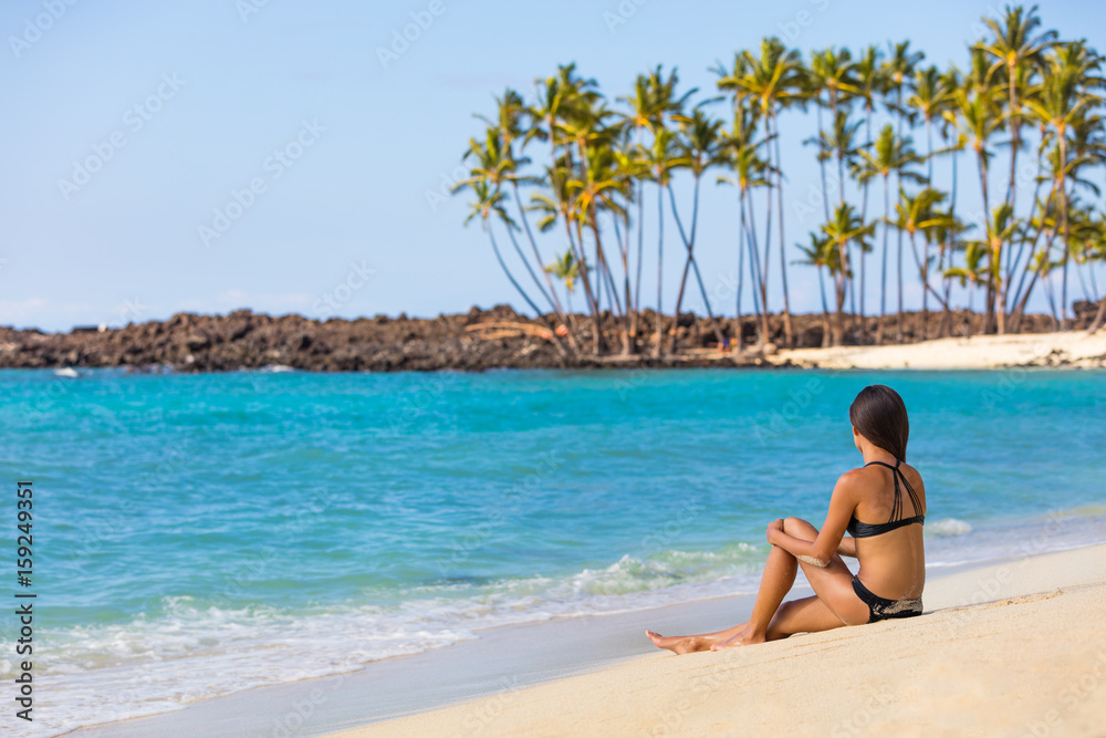 Hawaii beach travel tropical getaway bikini girl on Big island. Hawaiian tropical nature landscape with palm trees and volcanic beach in background. Hawaii beach travel tropical getaway bikini girl on Big island. Hawaiian tropical nature landscape with palm trees and volcanic beach in background.