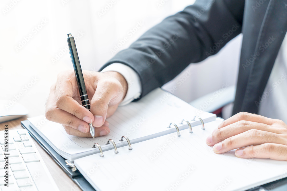 Close-up hand of businessman writing Close-up hand of businessman writing