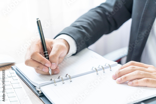 Close-up hand of businessman writing