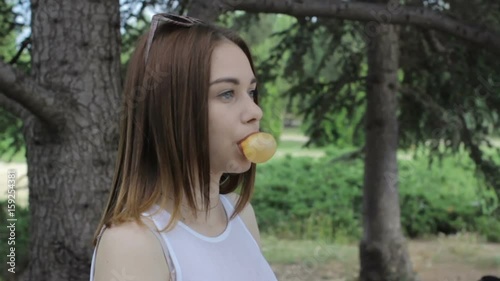 Young pretty girl chews a gum, outdoor  