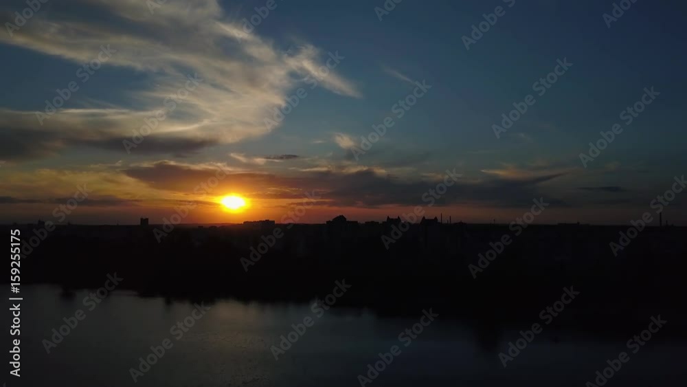 Flying over the trees and lake in the city at dawn - aerial videotaping Flying over the trees and lake in the city at dawn - aerial videotaping