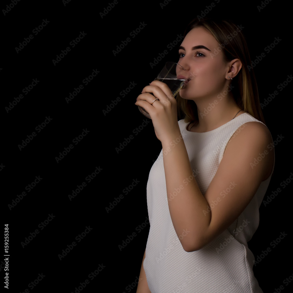 Young pretty woman drinks water Bottle or glass of spring water Young pretty woman drinks water Bottle or glass of spring water