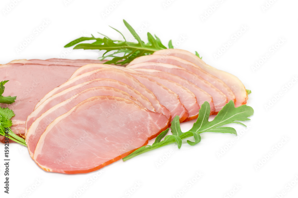 Sliced cooked pork loin and ham with greens closeup