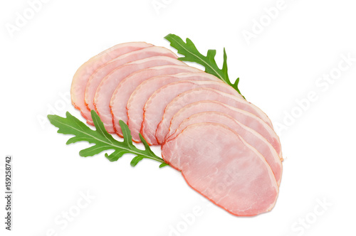 Sliced cooked pork loin with arugula leaves