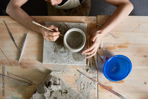 Charming woman cut out patterns on potter