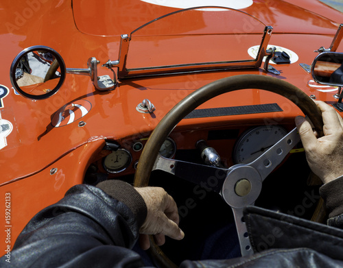 Close-up of the cockpit of vintage retro sports car..Visible the steering wheel, fuel level indicator, oil pressure and water © peuceta