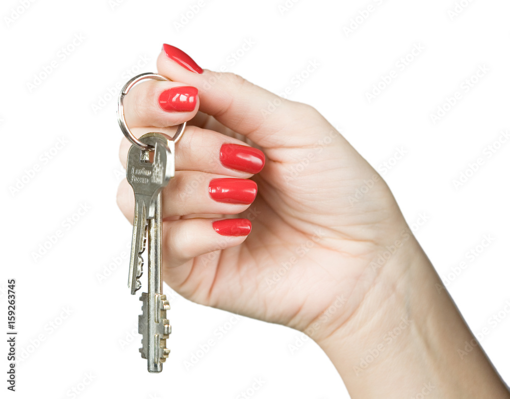 A woman's hand with a beautiful manicure holds a bunch of keys.