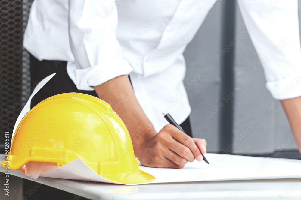 Architect working with construction tools and helmet safety on table Architect working with construction tools and helmet safety on table