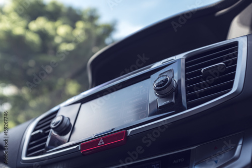 modern car dashboard with bokeh background of tree and sky, selective focus, filter effect
