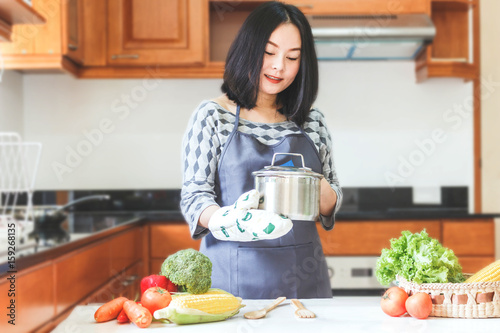 Woman with fresh vegetables in the kitchen