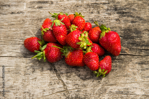 Ripe fresh strawberries on rustic wooden background. Top view