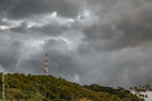 Communication tower at top of mountain with clouds