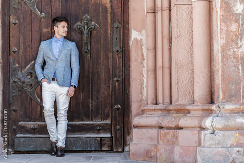Confident businessman standing near entrance