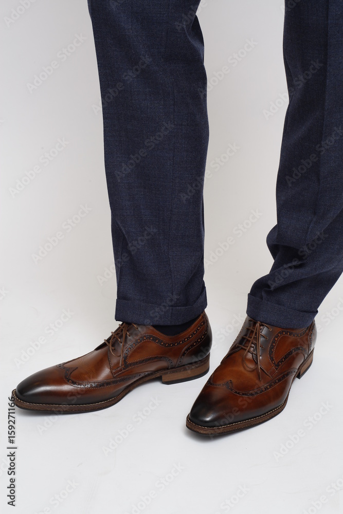 Close-up of trousers leg and fashionable men's shoes, isolated Close-up of trousers leg and fashionable men's shoes, isolated