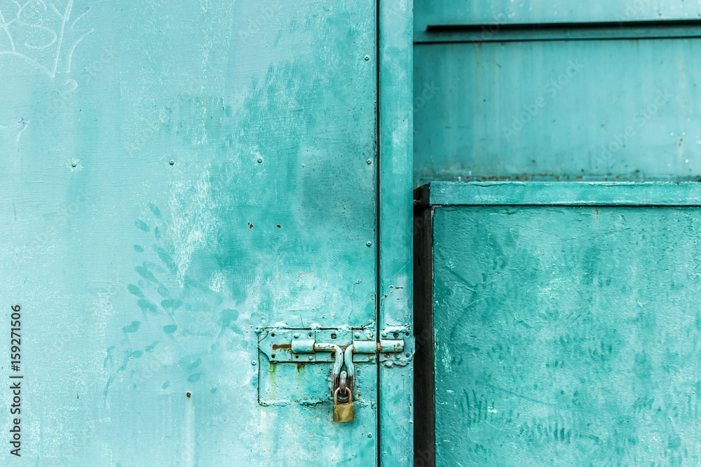 close up on green door with the key locked, abstract background with vintage filter. to show the old texture on metallic. close up on green door with the key locked, abstract background with vintage filter. to show the old texture on metallic.