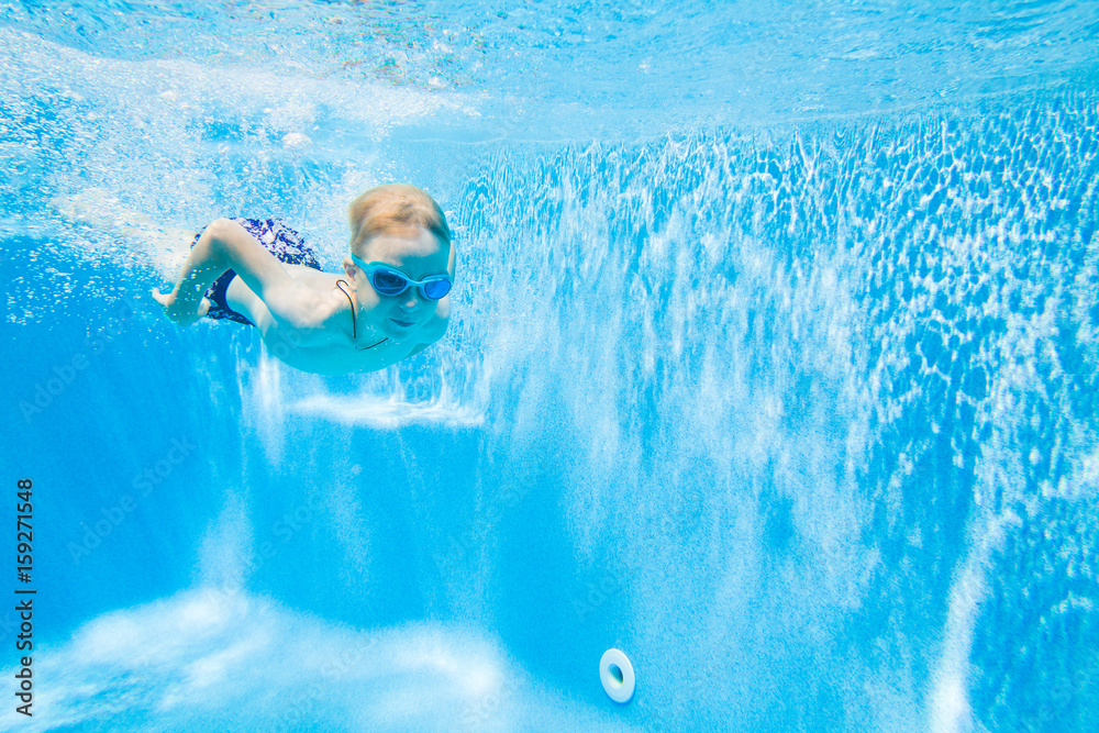 little boy swimming  in pool