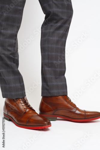 Fototapeta Naklejka Na Ścianę i Meble -  Close-up of trousers leg and fashionable men's shoes, isolated