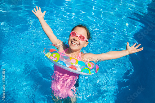 little girl swimming in pool