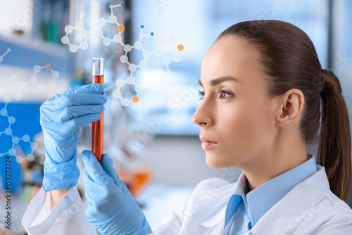 chemist with test tube in hands