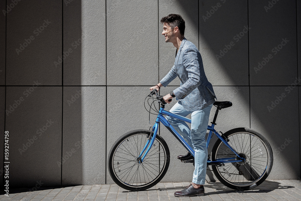 Fototapeta premium Hilarious smiling male person ready for bicycle trip