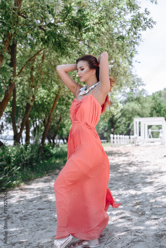 Summer fashion portrait of a beautiful young woman or girl on the beach Summer fashion portrait of a beautiful young woman or girl on the beach