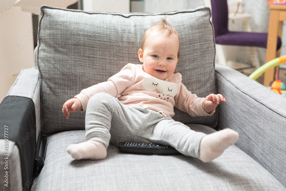 Seven months old baby girl sitting on a sofa Seven months old baby girl sitting on a sofa