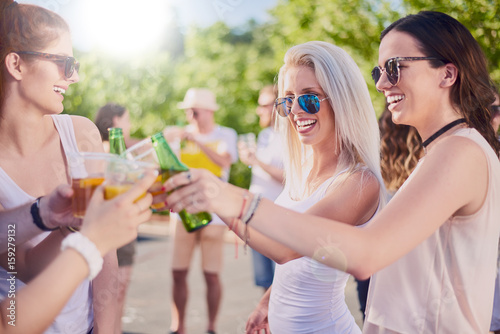 Group of friends making a toast, chatting and smiling st the party