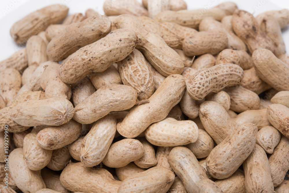 Dried peanuts on white plate at on white background Dried peanuts on white plate at on white background