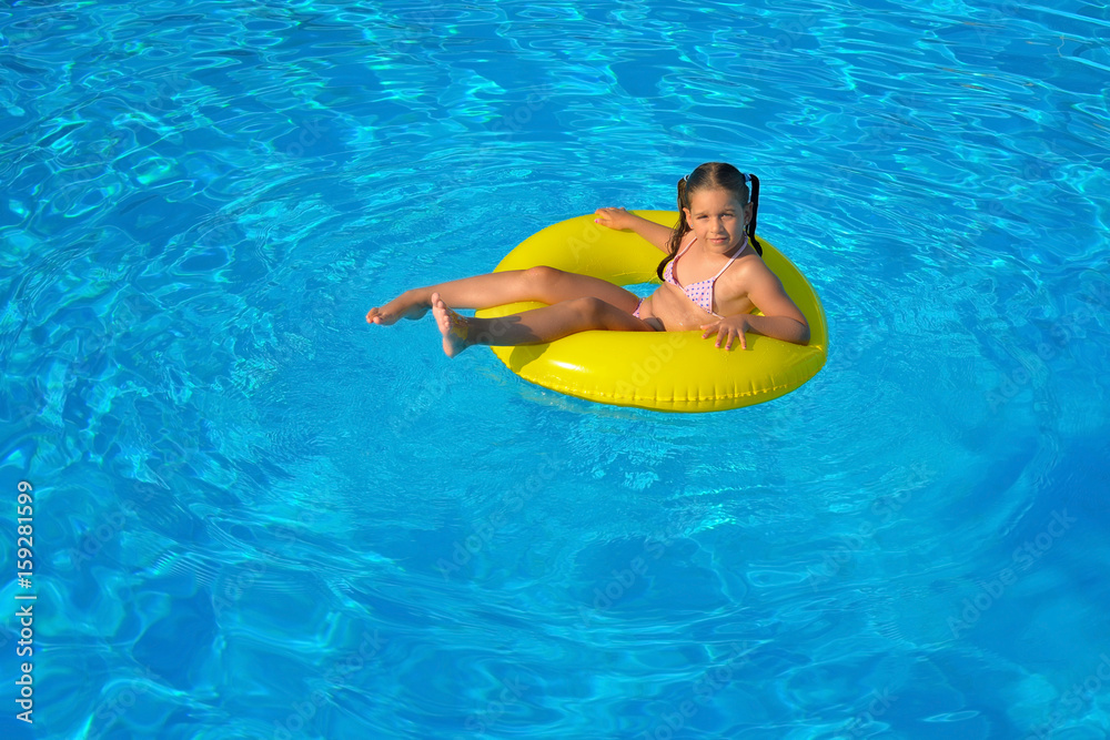 Adorable toddler relaxing in swimming pool