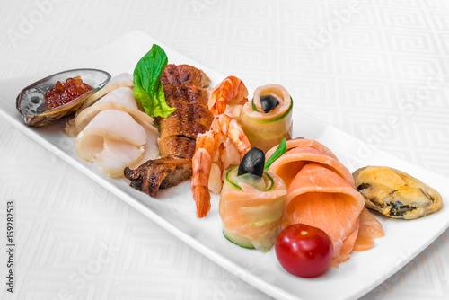 Delicious assorted seafood. Fish, shrimp, mussels and seashells. Horizontal frame
