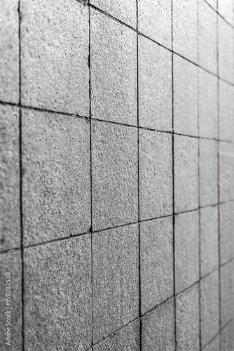 Background. Texture of gray square paving tiles on the entire frame. Vertical frame