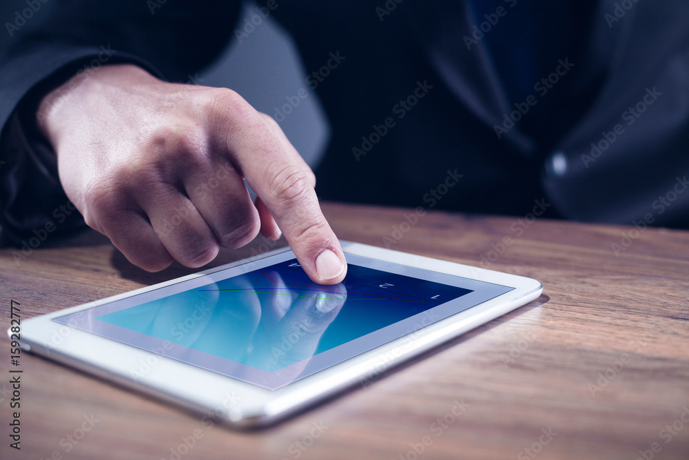 A mans hand touching on a tablet computer A mans hand touching on a tablet computer