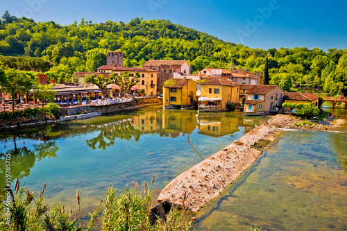 Mincio river and idyllic village of Borghetto view