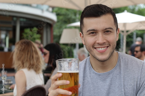 Happy man drinking a cold refreshing beer