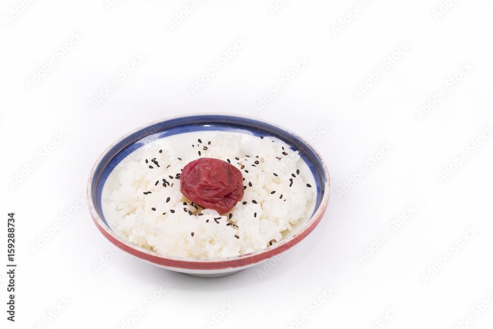 Japanese cuisine ,Japanese white rice and Traditional Japanese Umeboshi (plum pickle) with white background. Japanese cuisine ,Japanese white rice and Traditional Japanese Umeboshi (plum pickle) with white background.