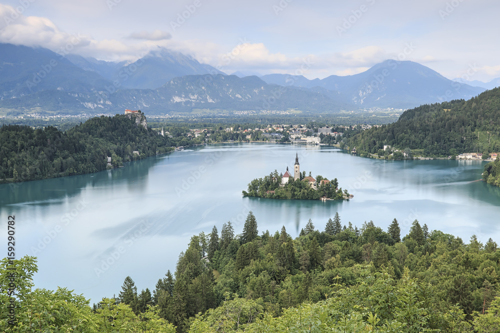 Aerial view of lake Bled at sunset with a view of the island church and the castle.