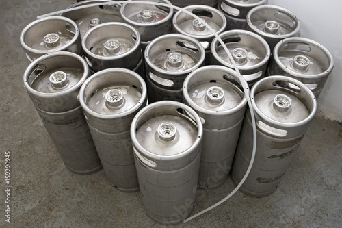 Stack of metal beer kegs in small craft brewery