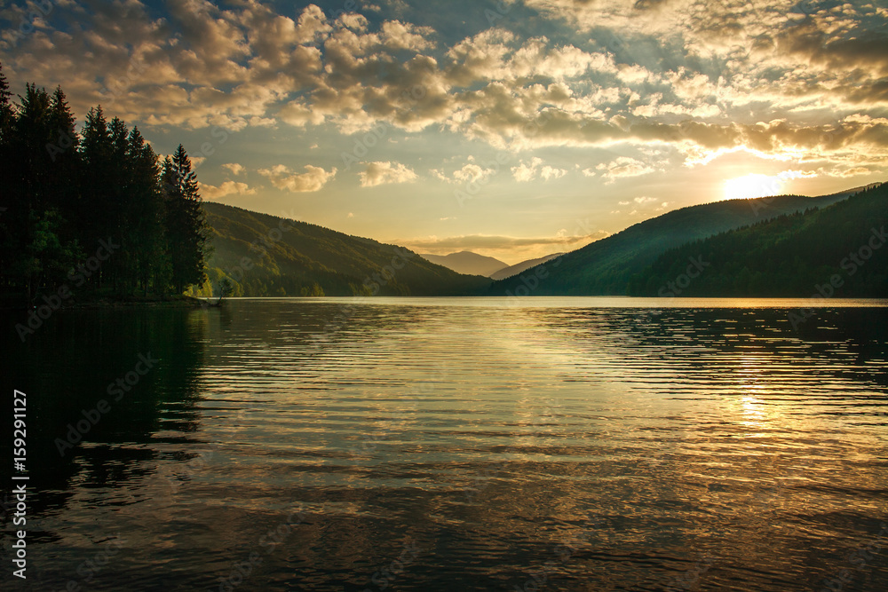 Fototapeta premium Mountain forest lake on background dramatic sunrise sky