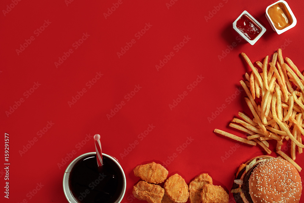 Burger and Chips. Hamburger and french fries in red paper box. Fast food on red background. Burger and Chips. Hamburger and french fries in red paper box. Fast food on red background.