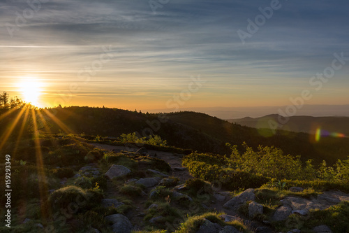 French countryside - Vosges. Sunrise in the Vosges with a hiking trail and rocks in the foreground. Rhine valley and Black Forest in the Background.