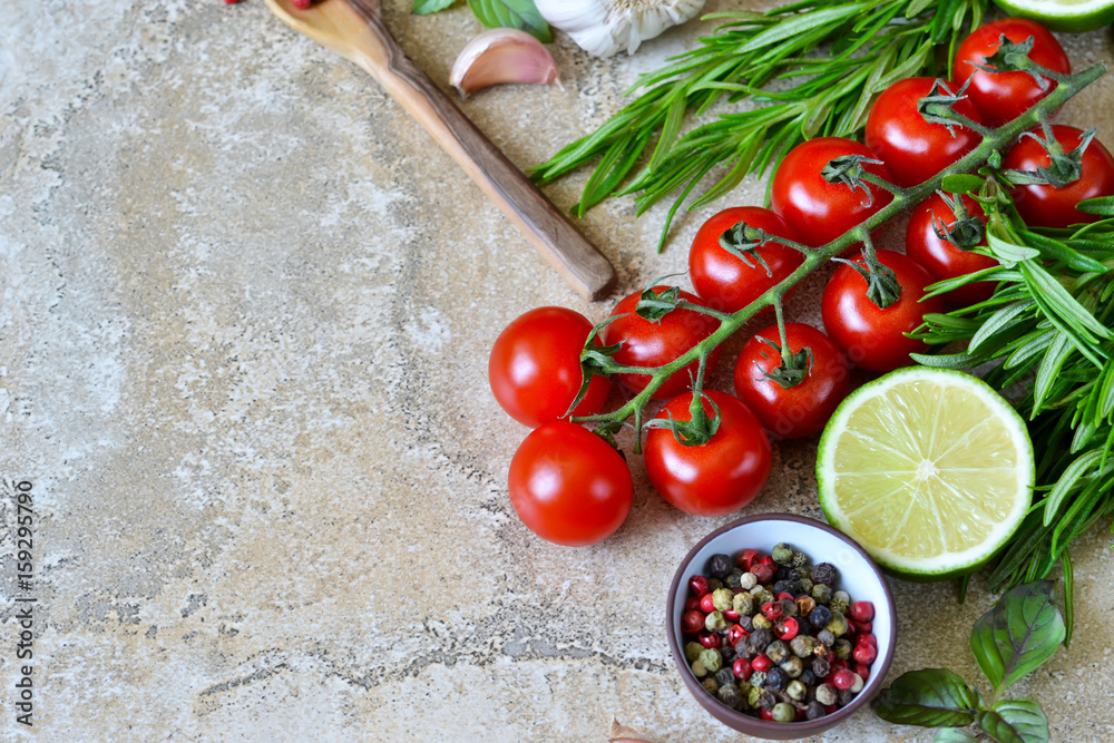 Food background with different ingredients on a marble background. Cherry tomatoes, rosemary, garlic, pepper, lime. Top view. Food background with different ingredients on a marble background. Cherry tomatoes, rosemary, garlic, pepper, lime. Top view.