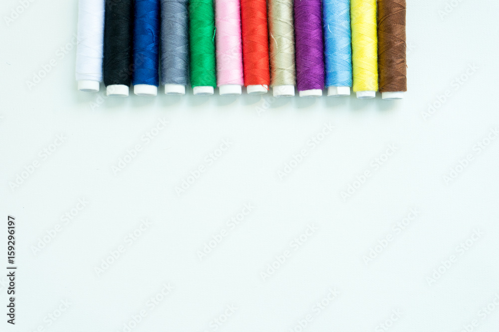 Spools of colours threads or call yarns on rolls for sewing isolated on white background