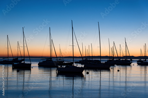 Fototapeta Naklejka Na Ścianę i Meble -  Various sails at sunset in lake Garda, Italy