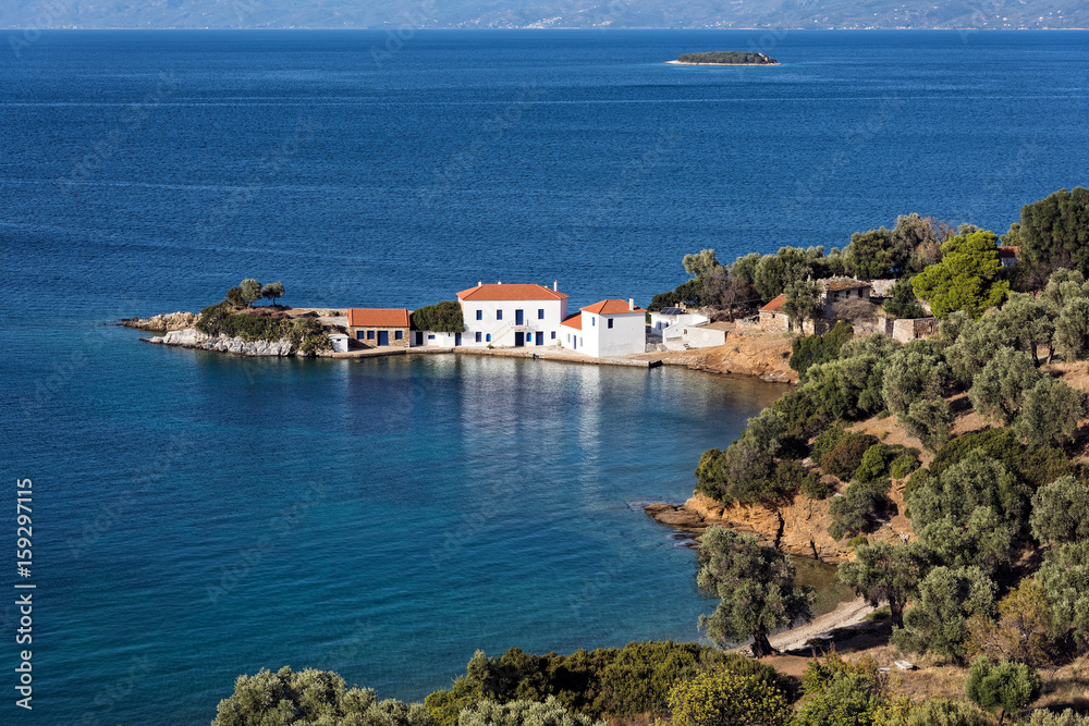 Typical mediterranean landscape with white houses, olive trees and blue sea in Pagasetic Gulf in Thessaly, Greece