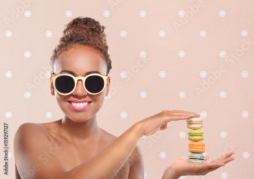 Young woman holding pile of...