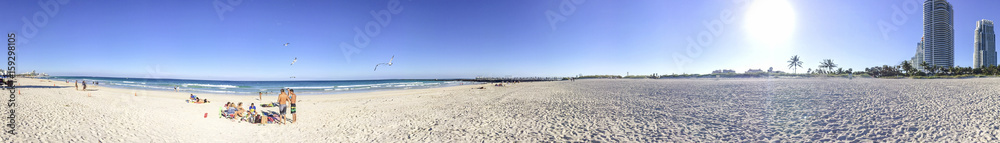 MIAMI BEACH, FL - FEBRUARY 2016: Tourists along the ocean. The city is a major attraction in Florida MIAMI BEACH, FL - FEBRUARY 2016: Tourists along the ocean. The city is a major attraction in Florida