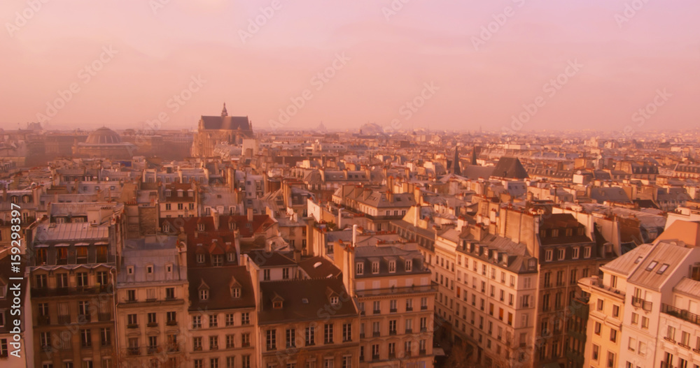 View of Paris from above at sunset. Evening in Paris. Panorama of the roofs of Paris.