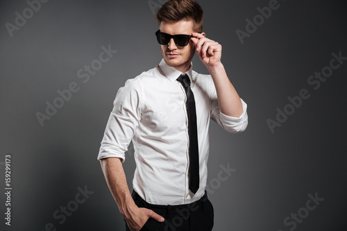 Serious young man dressed in formalwear